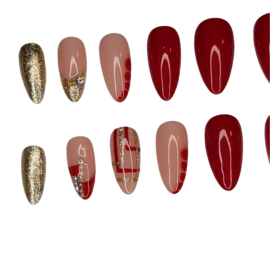 Nail art display with gold, red, and brown designs on a white background