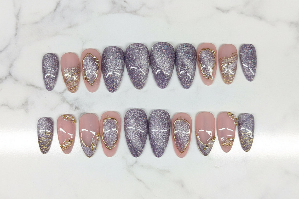 Row of nail art designs on a textured surface