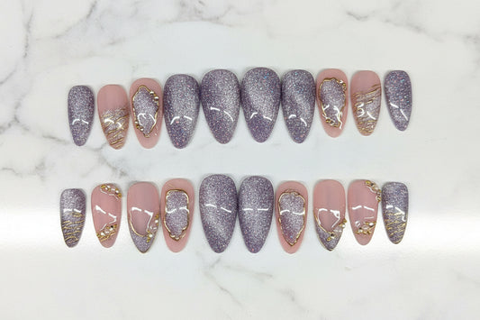 Row of nail art designs on a textured surface