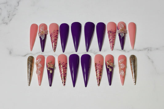 Set of decorative nail art on artificial nails with royal purple tone and the elegant 3D floral accents