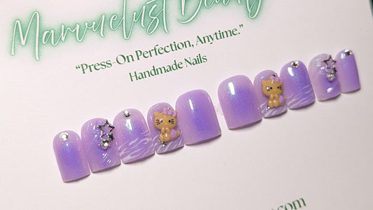 Set of purple press-on nails with decorative elements on a branded card.